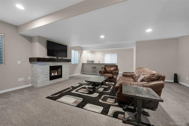 carpeted living room with recessed lighting, baseboards, and a tile fireplace