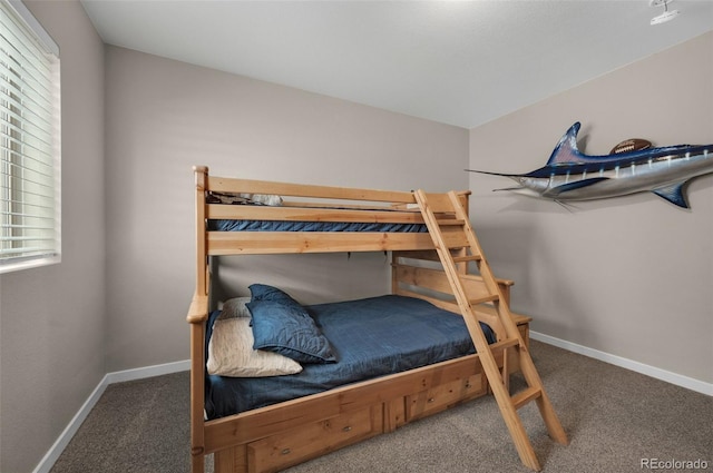 carpeted bedroom featuring baseboards