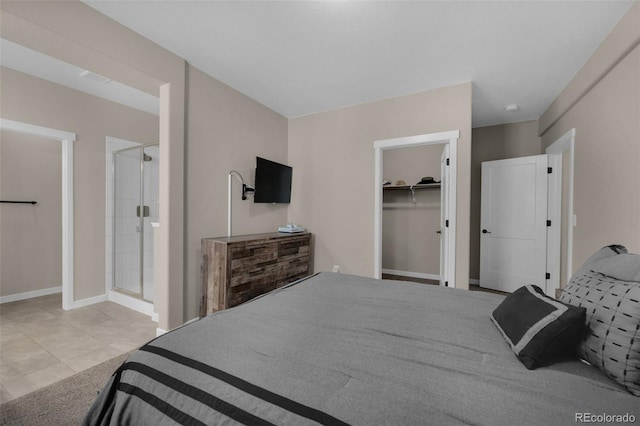 bedroom with baseboards and a walk in closet