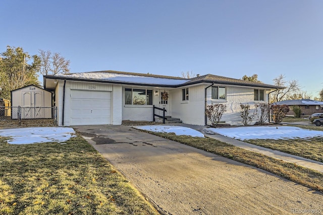 single story home featuring a front yard and a storage shed