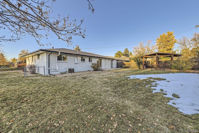 back of property featuring a gazebo and a yard