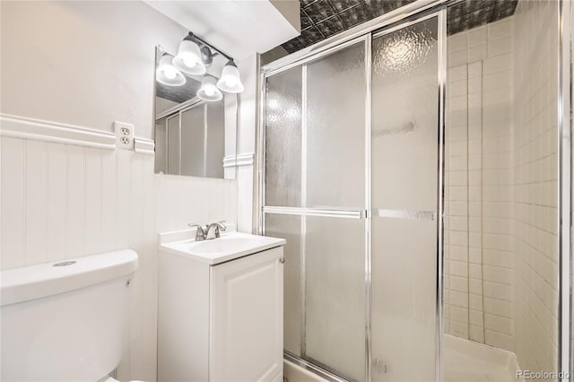 bathroom featuring an enclosed shower, vanity, and toilet