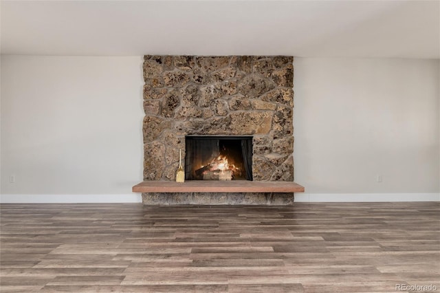 room details featuring a fireplace and wood-type flooring