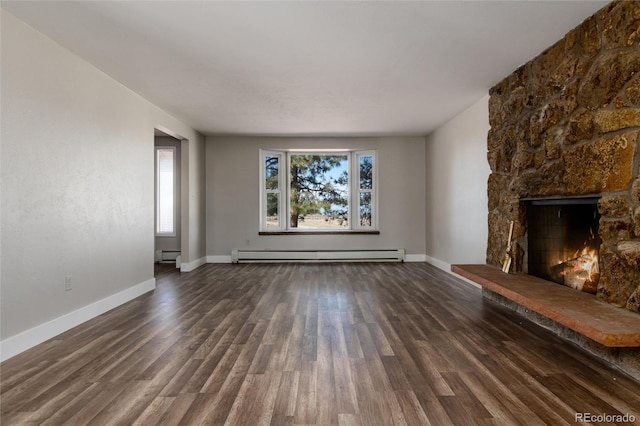 unfurnished living room featuring a stone fireplace, dark wood-type flooring, and a baseboard radiator