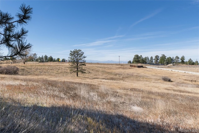 view of yard with a rural view