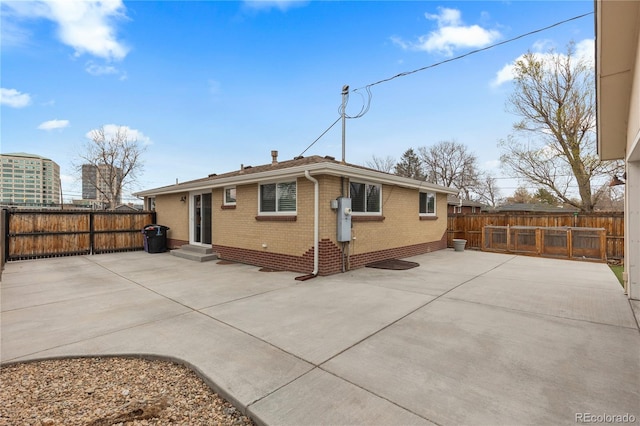 1996 S Dexter St, Denver, CO 80222 - rear view of property with a patio, brick siding, and a fenced backyard