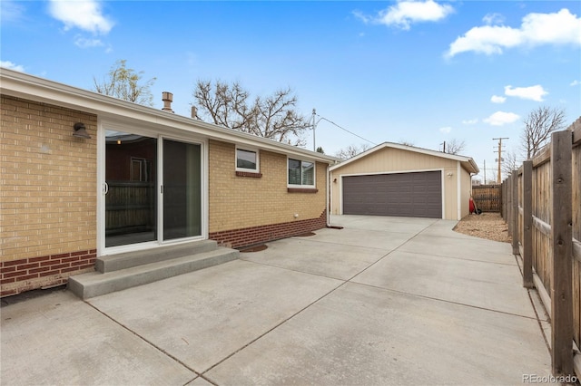 1996 S Dexter St, Denver, CO 80222 - view of side of home featuring a detached garage, entry steps, an outbuilding, and brick siding