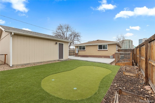 1996 S Dexter St, Denver, CO 80222 - fenced backyard with a putting green, a patio, and a vegetable garden