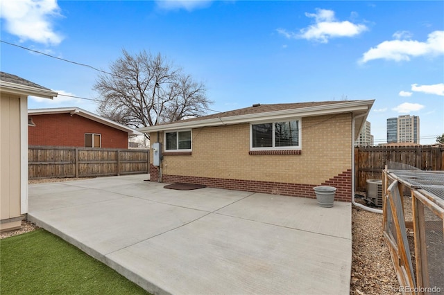 1996 S Dexter St, Denver, CO 80222 - back of house featuring a patio, brick siding, and a fenced backyard