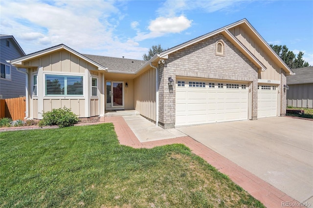 525 Badger Creek Dr, Brighton, CO 80601 - ranch-style home with board and batten siding, a garage, driveway, and a front lawn