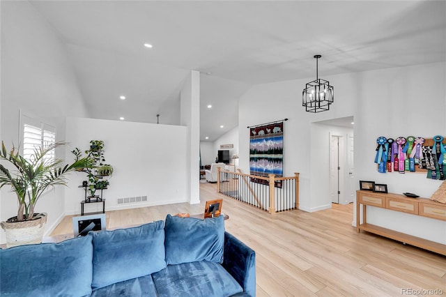 525 Badger Creek Dr, Brighton, CO 80601 - living room featuring high vaulted ceiling, light wood-style floors, a chandelier, and recessed lighting