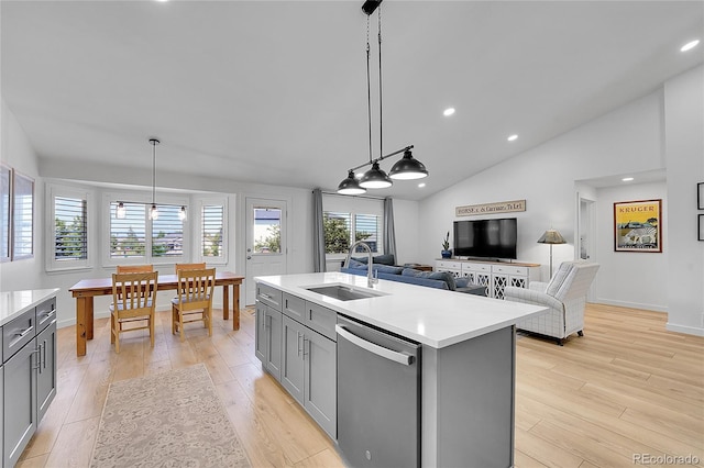 525 Badger Creek Dr, Brighton, CO 80601 - kitchen featuring stainless steel dishwasher, gray cabinetry, light countertops, light wood-style flooring, and open floor plan
