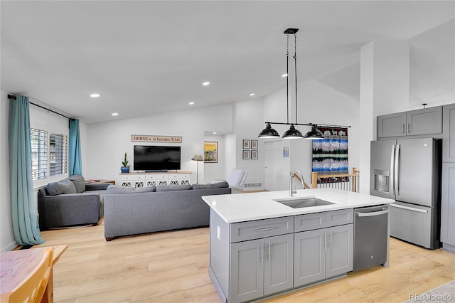 525 Badger Creek Dr, Brighton, CO 80601 - kitchen with stainless steel appliances, gray cabinetry, light wood-style flooring, light countertops, and high vaulted ceiling
