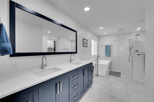 525 Badger Creek Dr, Brighton, CO 80601 - bathroom with a freestanding bath, recessed lighting, double vanity, and a walk in shower