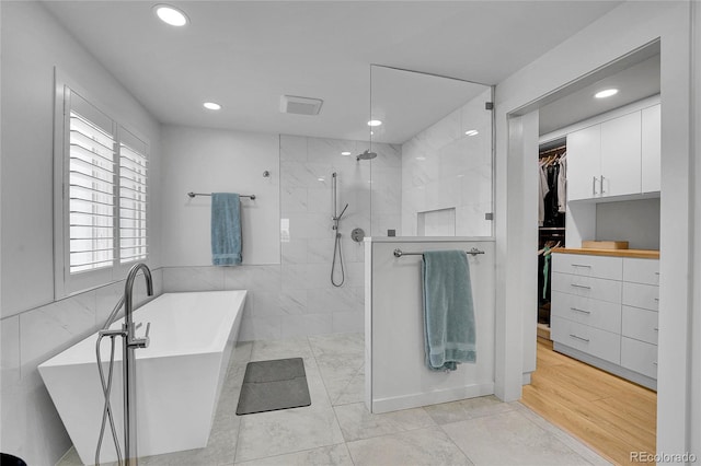 525 Badger Creek Dr, Brighton, CO 80601 - full bathroom featuring a walk in closet, a freestanding tub, walk in shower, and recessed lighting