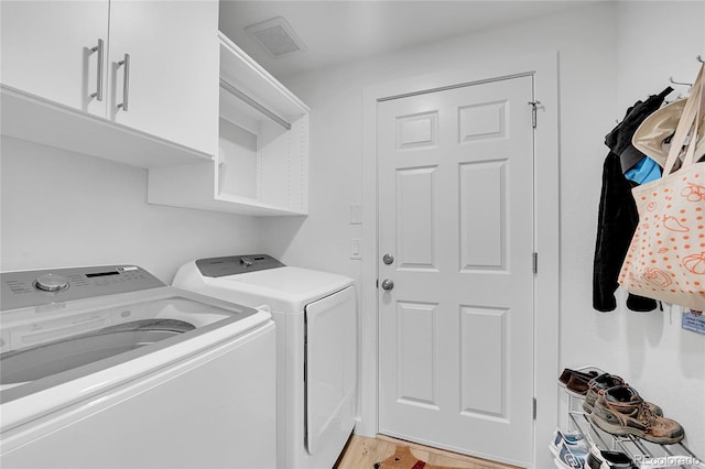 525 Badger Creek Dr, Brighton, CO 80601 - washroom featuring washer and clothes dryer, cabinet space, and light wood-style flooring