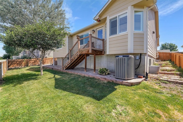 525 Badger Creek Dr, Brighton, CO 80601 - rear view of house featuring a fenced backyard, stairway, and a wooden deck