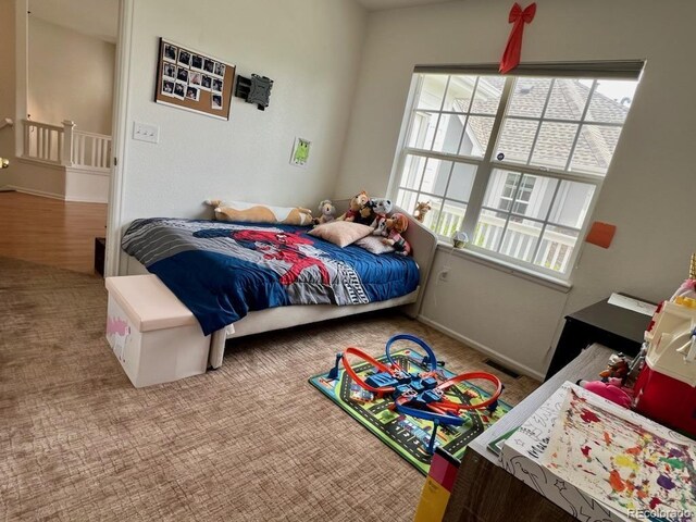 bedroom featuring multiple windows and carpet floors