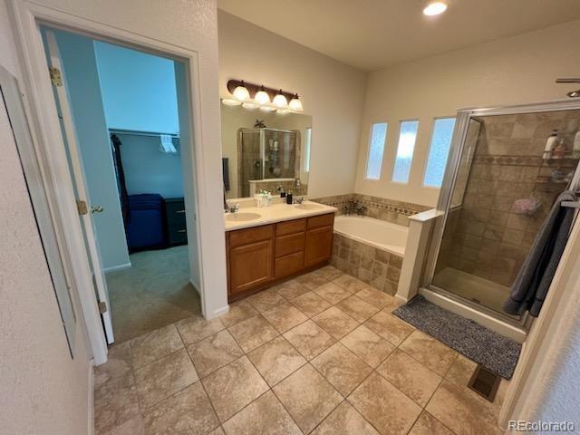 bathroom featuring vanity, separate shower and tub, and tile patterned flooring