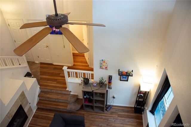 living room featuring dark hardwood / wood-style floors and ceiling fan