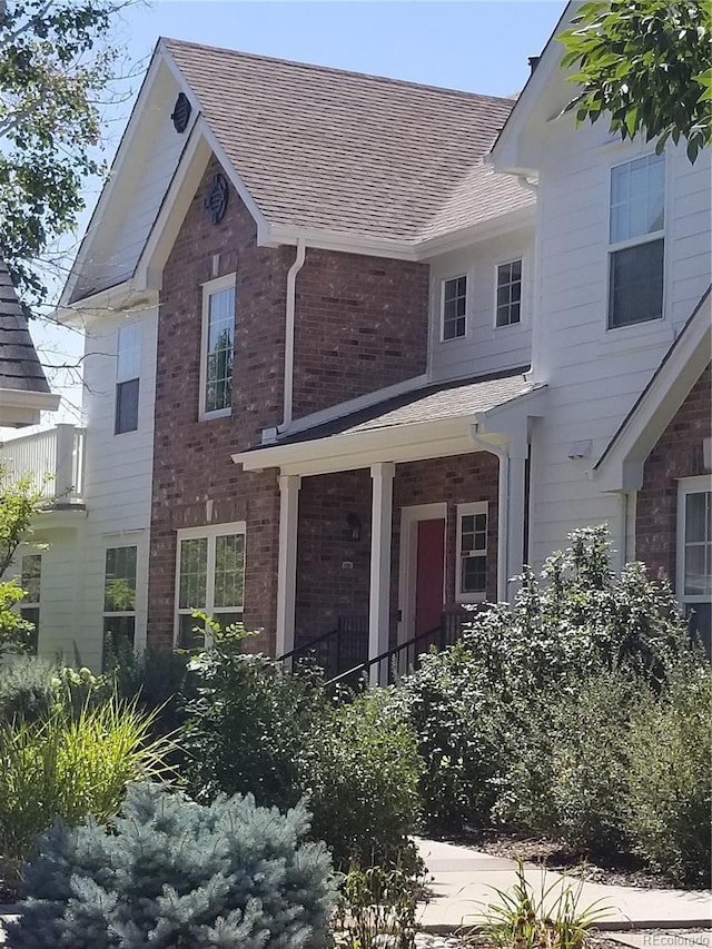8802 E 24th Pl Unit 101, Denver, CO 80238 - view of front of property featuring brick siding and roof with shingles