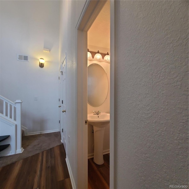 8802 E 24th Pl Unit 101, Denver, CO 80238 - hallway with wood finished floors and a textured wall