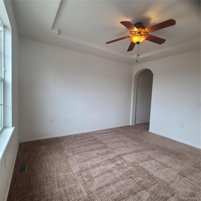 8802 E 24th Pl Unit 101, Denver, CO 80238 - carpeted empty room with a tray ceiling, arched walkways, and ceiling fan