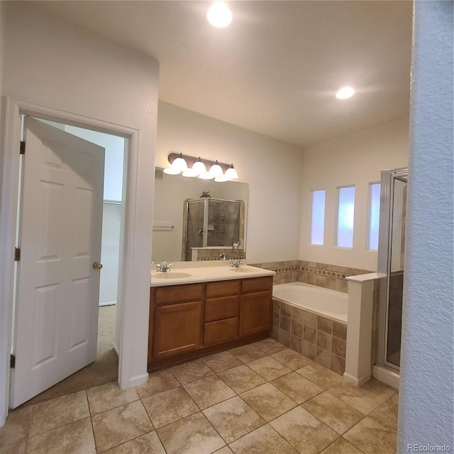 8802 E 24th Pl Unit 101, Denver, CO 80238 - full bathroom featuring a garden tub, double vanity, a shower stall, tile patterned flooring, and recessed lighting