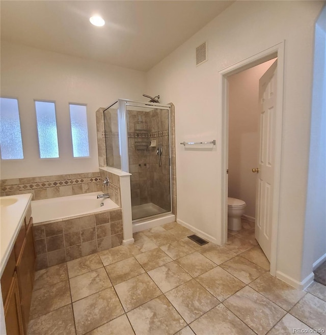 8802 E 24th Pl Unit 101, Denver, CO 80238 - bathroom featuring a garden tub, a shower stall, toilet, vanity, and tile patterned floors