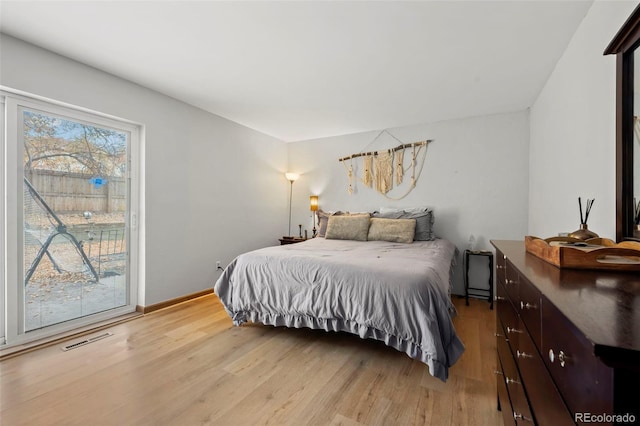 bedroom featuring access to outside and light hardwood / wood-style flooring