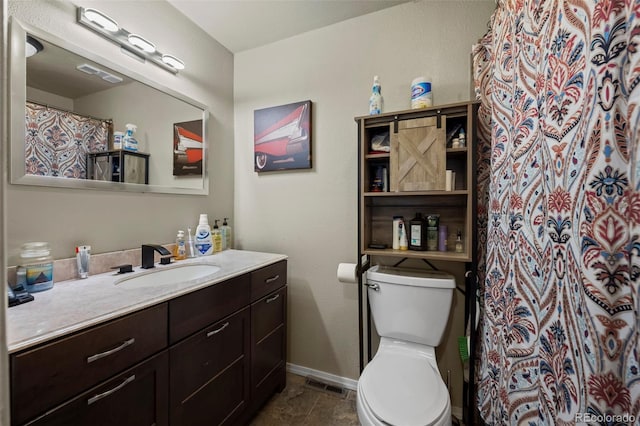 bathroom featuring toilet, a shower with curtain, vanity, and tile patterned flooring