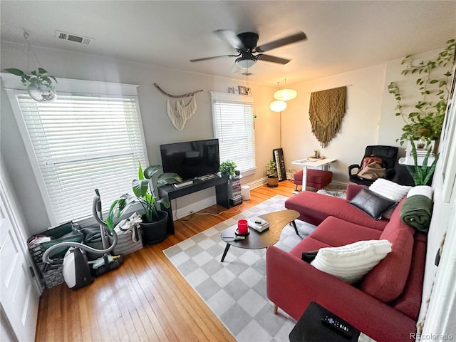 living room featuring hardwood / wood-style floors and ceiling fan