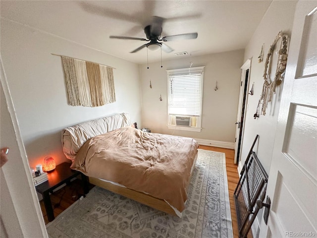 bedroom with ceiling fan and light hardwood / wood-style floors