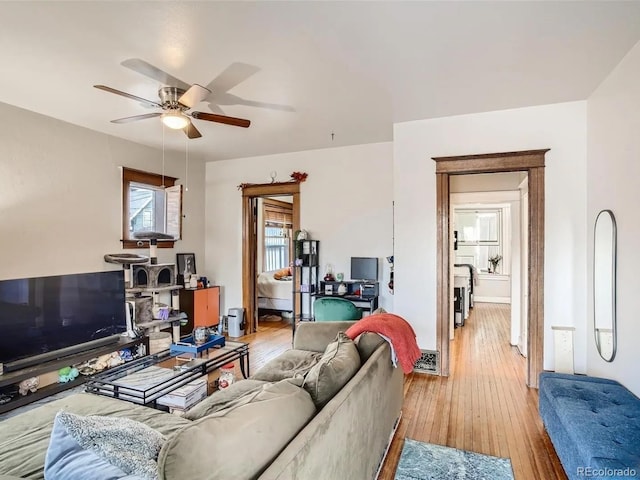 living room with ceiling fan and light wood-type flooring