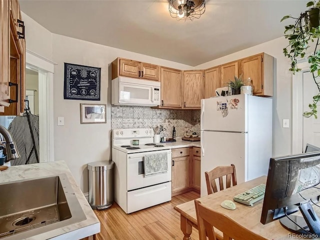 kitchen with white appliances, light hardwood / wood-style floors, backsplash, and sink