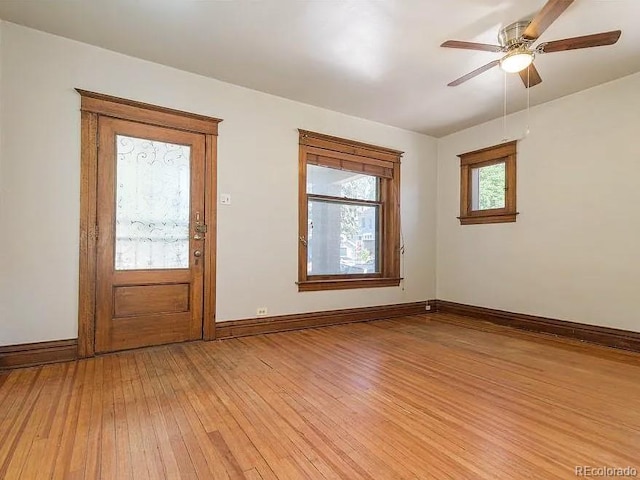 foyer with ceiling fan and light wood-type flooring