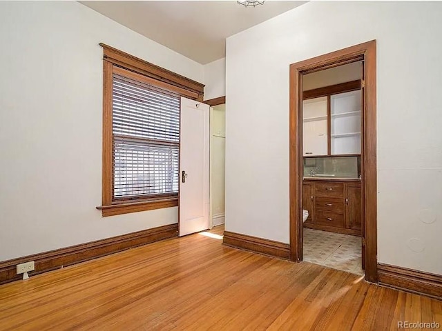 interior space featuring ensuite bathroom and light hardwood / wood-style flooring