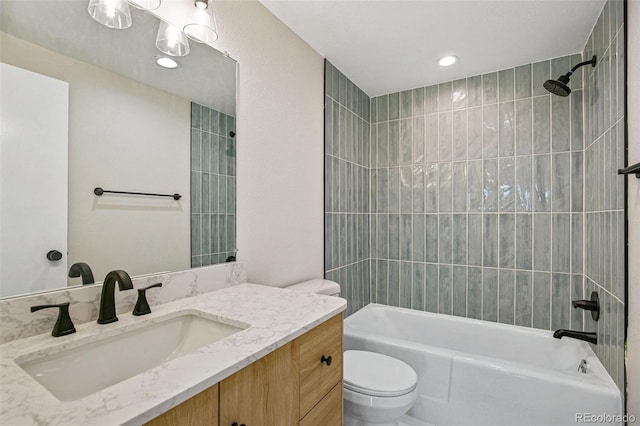 full bathroom with vanity, toilet, and tiled shower / bath