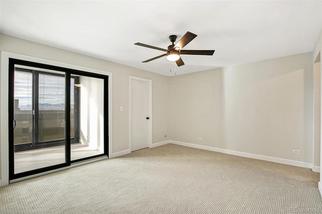 spare room featuring ceiling fan and light colored carpet