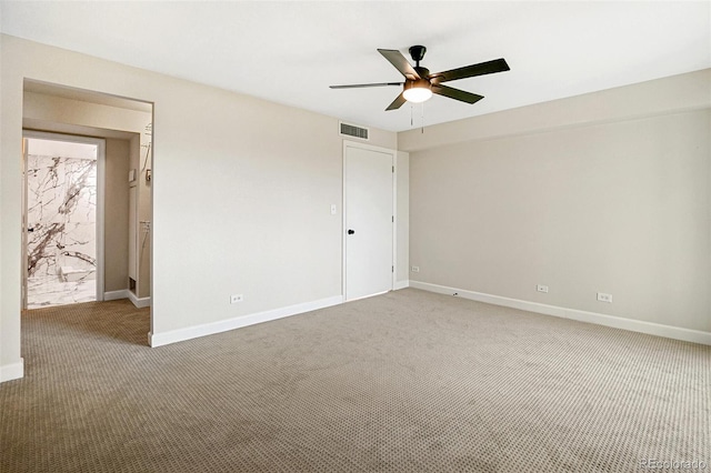 carpeted empty room featuring ceiling fan