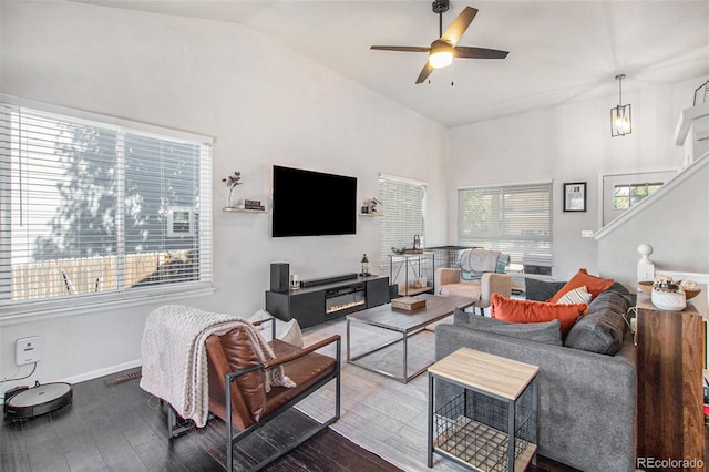 living room with lofted ceiling, ceiling fan, and hardwood / wood-style flooring