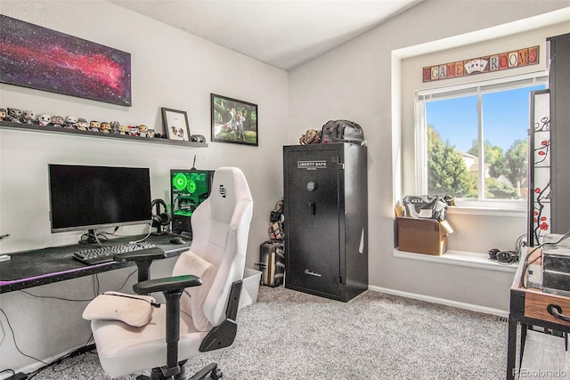 carpeted home office with vaulted ceiling