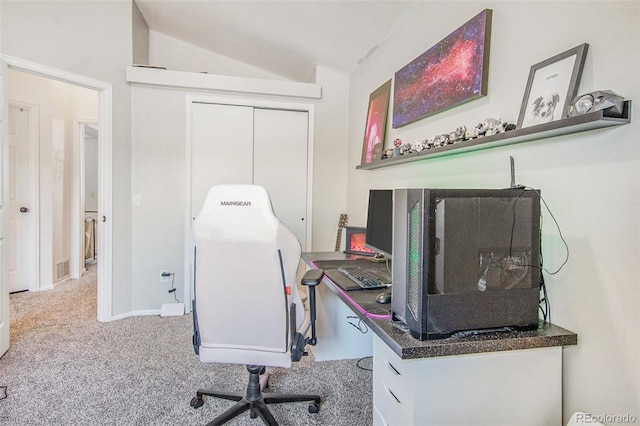 office area featuring vaulted ceiling and light colored carpet