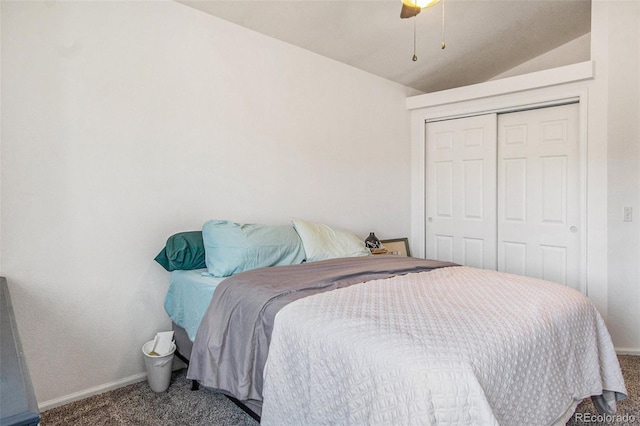 carpeted bedroom with ceiling fan, lofted ceiling, and a closet