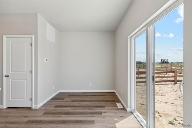 7307 Dolores Ave, Frederick, CO 80530 - empty room with plenty of natural light and wood finished floors