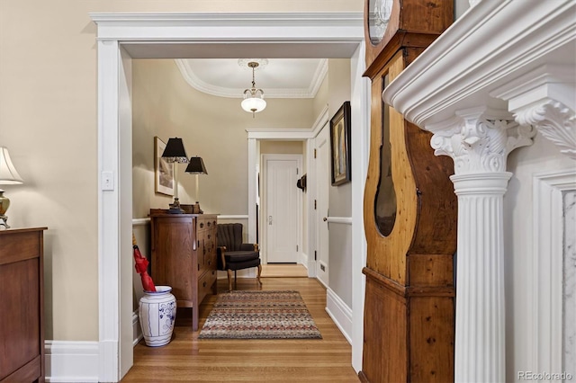 836 E 17th Ave Unit 1A, Denver, CO 80218 - foyer entrance featuring light wood-type flooring, decorative columns, and ornamental molding
