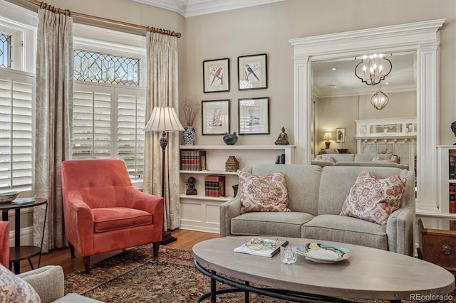 836 E 17th Ave Unit 1A, Denver, CO 80218 - living area with crown molding, wood finished floors, and a chandelier