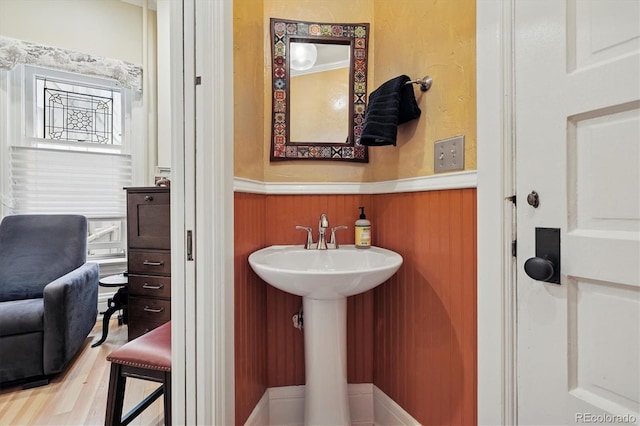 836 E 17th Ave Unit 1A, Denver, CO 80218 - bathroom with a wainscoted wall and wood finished floors
