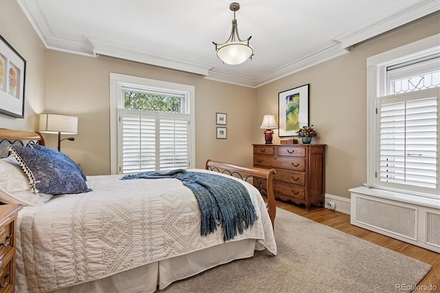 836 E 17th Ave Unit 1A, Denver, CO 80218 - bedroom with crown molding, wood finished floors, and radiator