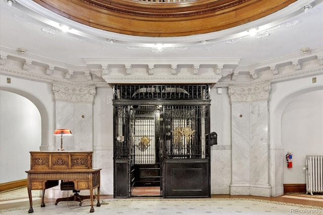 836 E 17th Ave Unit 1A, Denver, CO 80218 - wine room with radiator heating unit, arched walkways, and crown molding